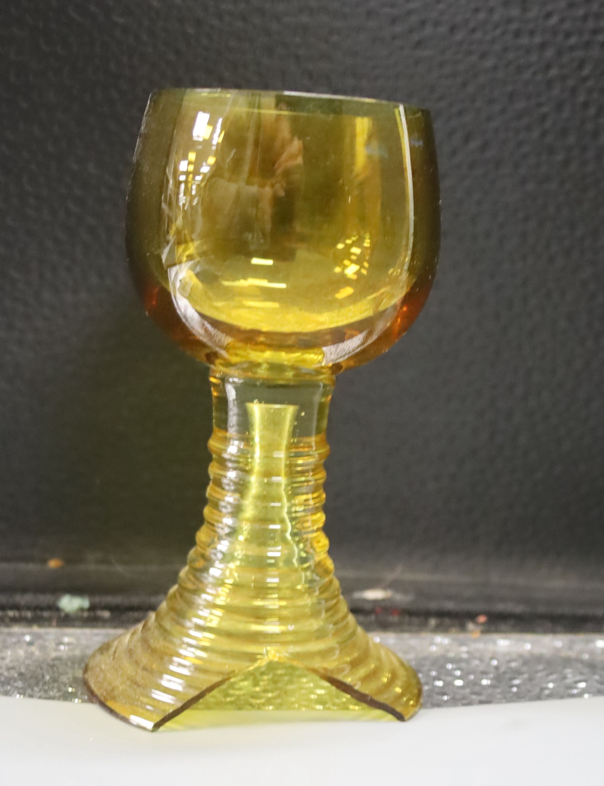 Fourteen German amber flashed roemers, nine wheel engraved with vines